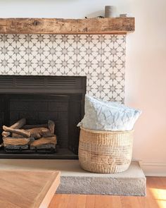 a living room with a fire place next to a basket on top of the fireplace