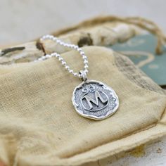 An initial or monogram is a sign of identity. Wear it to show off your own beautiful identity or wear several to show off those who have created a lasting impression in your heart. Our Lasting Impressions Necklace comes to you in handcrafted sterling silver and on a 16" chain. If you prefer a longer length, you can select 18, 20, 24 or 30 inches for a small additional fee. This designer monogram necklace replicates the the lost art of wax seals to identify the writer. Each silver monogram is cre Sterling Silver Monogram Charm Necklace For Mother's Day, Classic Sterling Silver Monogram Necklace, Silver Monogram Charm Necklace For Mother's Day, Mother's Day Sterling Silver Monogram Charm Necklaces, Personalized Silver Monogram Charm Necklace, Mother's Day Sterling Silver Monogram Charm Necklace, Personalized Monogram Silver Charm Necklace, Monogram Medallion Necklace For Anniversary, Anniversary Monogram Medallion Necklace