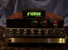 an electronic clock sitting on top of a counter