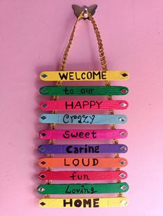 a sign that says welcome to one happy crazy sweet caring loud fun home hanging on a pink wall