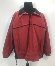 a red jacket hanging on a white wall