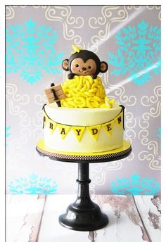 a cake with a monkey sitting on top of it