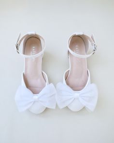 This flower girls block heels adorn with a charming tulle bow detail adds a touch of an elegance and grace for little princess for birthday party, holiday party, wedding party, flower girls, quinceanera shoes, and other special occasions.DETAILS:HEEL HEIGHT: 2 inchesCOLORS AVAILABLE: White and IvoryUPPER: Synthetic upper and liningMATERIALS: Manmade outsole Closed Toe Wedding Shoes With Bow For Bridesmaids, Bridesmaid Wedding Shoes With Bow And Closed Toe, Low Heel Bridesmaid Wedding Shoes With Satin Bow, Bridesmaid Low Heel Wedding Shoes With Satin Bow, Bridesmaid Wedding Shoes With Satin Bow And Low Heel, White Satin Wedding Shoes For Formal Occasions, Formal White Satin Wedding Shoes, Spring Wedding Shoes With Satin And Round Toe, Satin Round Toe Wedding Shoes For Spring