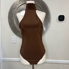 Wayf Brown Turtle Neck Sleeveless Body Suit- Size M Length: 30” Underarm To Underarm: 15” Materials: 96% Polyester, 4% Spandex Fitted Sleeveless Tank Top, Fitted Halter Vest Top For Beach, Brown Fitted Cami Tank Top, Chic Fitted Sleeveless Vest, Fitted Sleeveless Halter Top For Beach, Elegant Stretch Halter Vest Top, Brown Stretch Halter Neck Tank Top, High Neck Tank Top For Summer Nights, High Neck Tank Top For Summer Nights Out