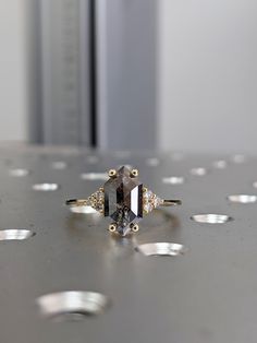 a diamond ring sitting on top of a table