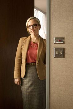 a woman standing in front of a door