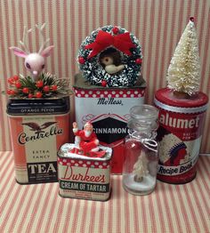 an assortment of tin canisters with christmas decorations