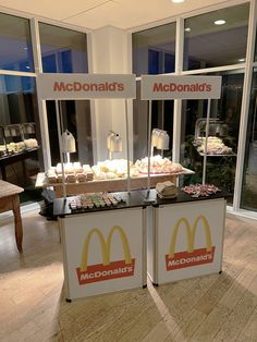 two mcdonald's stand displays food in front of windows