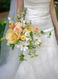 a bride holding a bouquet of flowers in her hand