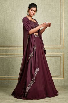 Plum layered cape with floral embroidered motifs. Paired with floral embroidered waistband lehenga and embroidered blouse.
Component: 3
Embroidered
Neckline: Leaf 
Sleeve Length: Elbow
Fabric: Paper silk, Tussar Silk, Georgette
Color: Maroon
Layered cape - Aza Fashions Georgette Sets With Cape Sleeves For Eid, Evening Sets With Intricate Embroidery In Georgette, Evening Cape Sets Made Of Georgette, Elegant Cape Style Georgette Lehenga, Georgette Cape Sets For Reception, Diwali Silk Sets With Cape Sleeves, Evening Dupatta With Floral Embroidery In Traditional Drape, Festive Gown With Zari Work And Cape Sleeves, Anarkali Evening Set With Cape Sleeves