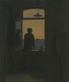 two people standing in front of a window looking out at the ocean