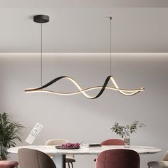 a modern dining room with pink chairs and a white table