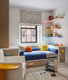 a child's room with a bed, chair and bookshelf in it