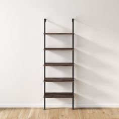 an empty shelf against a white wall in the corner of a room with wooden floors