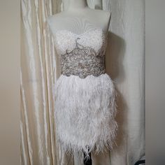 White, Ostrich Feather, Beaded, Cocktail Dress. Tag Says Size 10. However, It's A S/M. Measurements: Bust: 34 Waist: 28 Hips: 38 White Fitted Sleeveless Flapper Dress, White Feathered Mini Dress For Cocktail, White Feathered Mini Dress For Cocktails, White Feathered Mini Dress For Evening, White Glamorous Flapper Dress, Formal White Mini Dress With Feather Trim, Glamorous Fitted White Flapper Dress, Elegant White Flapper Dress For Cocktail, White Fitted Mini Dress With Feathers