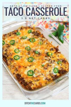 a casserole dish with cheese, green peppers and meat in it on a wooden table