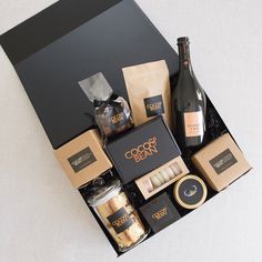 an assortment of wine and snacks in a gift box