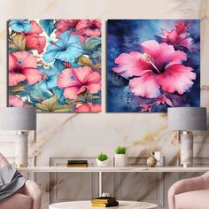 two pink and blue flowers are hanging on the wall