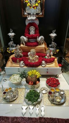 a table topped with lots of different types of food and silver ware on top of it