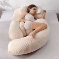 a woman laying on top of an inflatable pillow