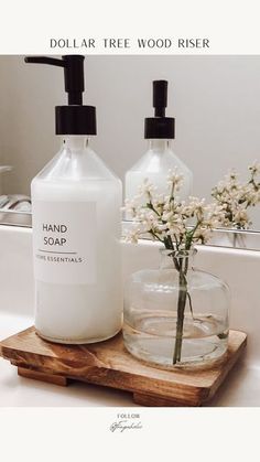 two soap dispensers sitting on top of a wooden tray