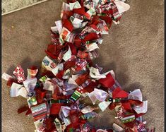 a pile of candy on the floor next to a carpeted area with a red and white ribbon