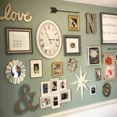 a wall with pictures, frames and a clock on it's side that says love