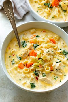 two white bowls filled with chicken noodle soup