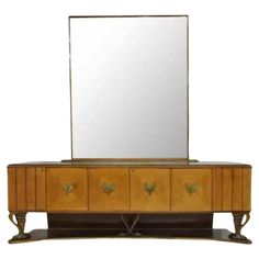 an art deco dresser with mirror on top