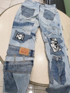 a pair of jeans with patches on them sitting on top of a table