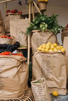 bags full of fruits and vegetables sitting on top of a table next to each other