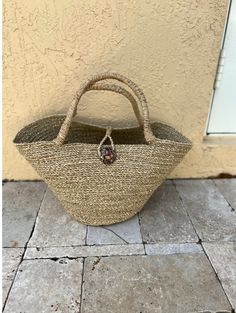 These gorgeous bags are designed and produced in South Africa.  Each one is made from painted sea grass that is then handwoven.  **real shell as clasp** As these are all handmade, slight variations may occur. Gold Top Handle Straw Bag For Vacation, Gold Top Handle Straw Bag For Beach, Gold Straw Bag With Braided Handles, Beach Bag With Rolled Handles In Natural Fiber, Handwoven Gold Straw Bag For Vacation, Elegant Natural Fiber Straw Bag For Beach, Natural Straw Bag With Rolled Round Handles, Beach Crochet Bag With Rolled Handles And Natural Fiber, Elegant Handwoven Basket Straw Bag