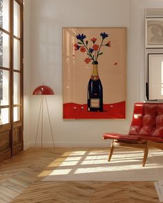 a room with a red chair and a painting on the wall in front of it