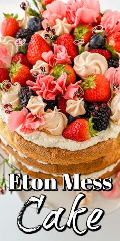 a close up of a cake with strawberries and flowers on the top that says eaton mess cake