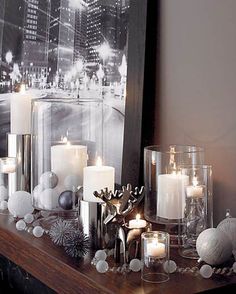 a mantle with candles and ornaments on it in front of a large cityscape