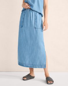 This indigo-dyed cargo skirt, fashioned from sustainable TENCEL™ fabric, has generous pockets, a drawstring waist, and side slits for ease of movement. The natural dye process makes each piece unique. Pairs beautifully with our matching chambray shirt. | This product’s overall fiber content is made with at least 50% of an environmentally preferred fiber. Learn more about our efforts to design planet-friendly apparel here. Details + Design: Hits at waist. Drawstring waist. Hits just above ankle. Cotton Maxi Skirt With Drawstring And Relaxed Fit, Cotton Maxi Skirt With Drawstring, Utility Skirt With Elastic Waistband, Cotton Long Skirt With Drawstring, Spring Medium Wash Cotton Cargo Skirt, Casual Medium Wash Relaxed Maxi Skirt, Casual Maxi Skirt With Pockets In Medium Wash, Casual Relaxed Skirt With Slip Pockets, Casual Skirt With Slip Pockets And Relaxed Fit