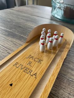 a wooden bowling board with four pins in it