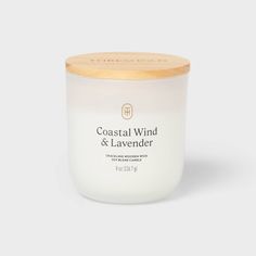 coastal wind and lavender candle in a glass jar with wooden lid on a white background