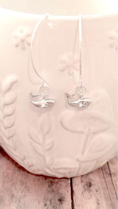 Nice little whale earrings! The sterling silver plated ear wires measure 1 2/5", and the zinc alloy whale charms measure  1/2" x 3/10" (Total length is approximately 2") All items are lead and nickel free, message with any questions, thanks! Silver Adjustable Fish Hook Earrings, Silver Dangle Earrings With Fish Hook, Adjustable Sterling Silver Fish Hook Jewelry, White Fish Hook Earrings As Gift, Sterling Silver Fish Hook Jewelry Gift, Sterling Silver Jewelry With Fish Hook For Gift, Whale Earrings, Whale Jewelry, Whale Gift