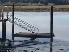 there is a boat dock that has been partially submerged in the water and broken down