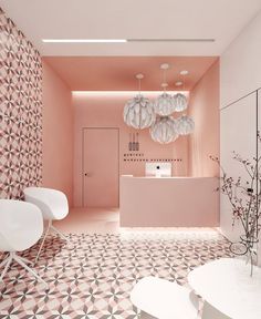 a bathroom with pink walls and flooring next to a white table in front of a mirror