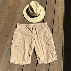 "Fantastic  pre-owned 90s khaki shorts with a comfortable relaxed fit.  Versatile Khaki beige colour, Several pockets, belt loops and a zipper and button closure   Size on tag is 10 - please check  measurements for accurate fit Measurements are taken  laid flat and doubled where needed Waist: 35\" Hip : 42\" Inseam : 10.5\" Length : 19.5\" Material: cotton 97%,  elastan 3% Brand: Jones New York Sport Condition: Very nice pre-owned, one side pocket as some fraying at edge, check photo." Utility Style Short Cargo Pants In Beige, Beige Utility Cargo Shorts With Cargo Pockets, Beige Short Utility Cargo Pants, Beige Utility Cargo Style Shorts, Beige Short Cargo Pants With Cargo Pockets, Beige Utility Shorts With Cargo Pockets, Beige Utility Cargo Pants Short Length, Beige Utility Cargo Shorts, Outdoor Cargo Pocket Bermuda Shorts