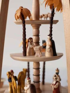 a wooden carousel with figurines on it