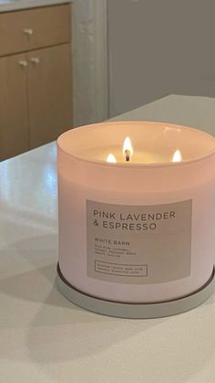 pink lavender and espresso scented candle on countertop in kitchen area with cabinets