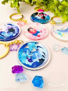 These clear keychains from the show [Steven Universe] come outfitted with a gold keyring and star charms to match the motif of the Crystal Gems. Each keychain design features a background matching a scene from the show! - About 1.75" in diameter - Single-sided - Clear transparent acrylic - Gold keyring Variations available: - Pearl (Pearl's Room) - Garnet (The Answer) - Amethyst (Amethyst's Room) - Lapis (Ocean Gem) - Steven (Rose's Room) Background Matching, The Crystal Gems, December 2024, Keychain Design, Crystal Gems, Star Charms, Steven Universe, Design Features, Garnet