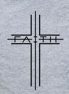 a cross with the word faith written in black on a grey shirt that says,