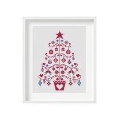 a cross stitch christmas tree with red, white and blue decorations