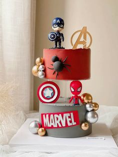 the cake is made to look like captain america and iron man figures on top of each other