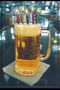 a beer mug with lit candles on it