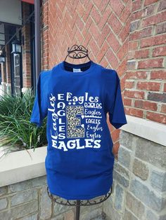 Customize a spirit tee that everyone will be jealous of under the Friday night lights! Don’t see your school here? Message us to order! Blue School Spirit T-shirt With Text Print, End Of School Year College T-shirt With Letter Print, Graphic Tee With Text Print For College Events, Blue T-shirt With Name Print For Game Day, Blue Name Print T-shirt For Game Day, Blue College T-shirt With Name Print, School Spirit T-shirt With Letter Print For College Events, Blue School T-shirt With Text Print, Blue Text Print T-shirt For School